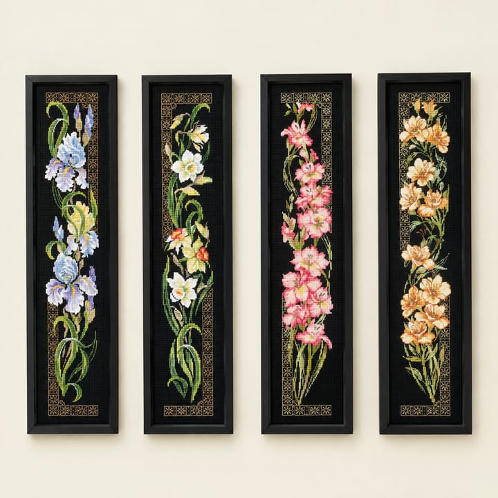 Iris, daffodil, pink orchid and peach orchid cross stitch panels on black Aida, framed side by side