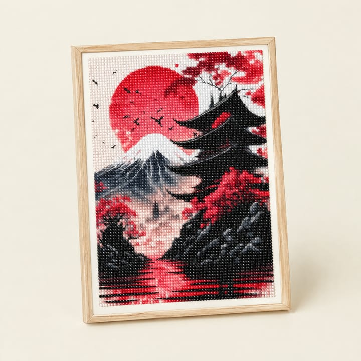 Red sun Fuji canvas framed beside a woven basket and a palm