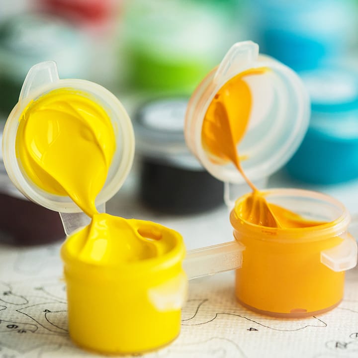 Open pots of acrylic paint from the kit