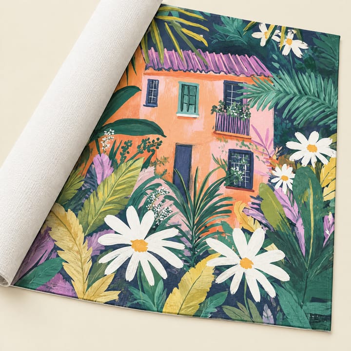 Garden house design: a pink house behind daisies and tropical leaves