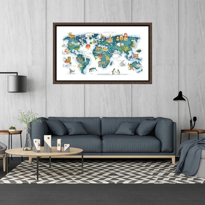 Framed world map cross stitch above a gray sofa