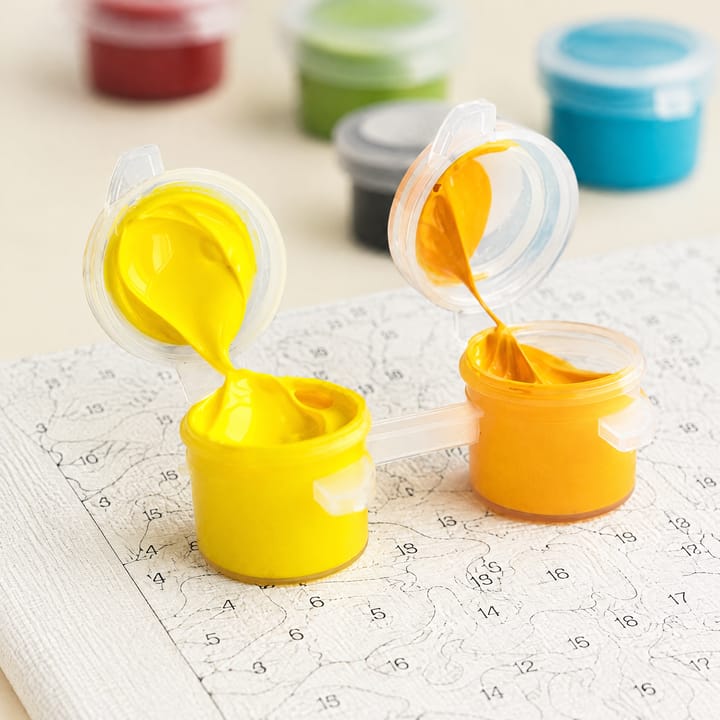 Open pots of acrylic paint from the kit